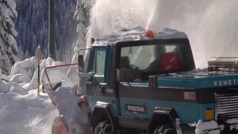 Snow blower removing snow from mountain road. Stock Footage 123787411