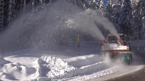 Snow blower removing snow from mountain road. Stock Footage 123787537
