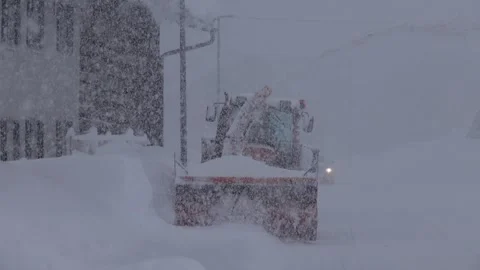 Snow blower in use during heavy snowfall Stock Footage 277802399