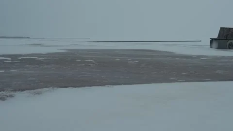 Snow blowing across a sandy beach in winter, close-up Stock Footage 330923908
