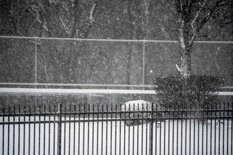 Snow Blowing by the Fences Stock Photos