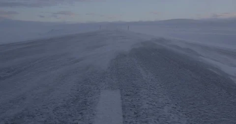 Snow blowing off the land surface due to heavy wind at sunset Video stock 103807484