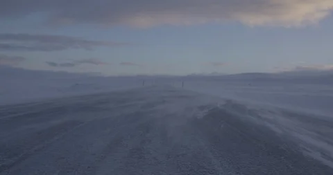 Snow blowing off the land surface due to heavy wind at sunset Stock Footage 103807507