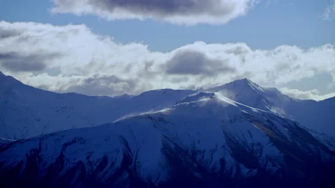 Snow blowing off a mountain ridge Stock Footage 159716820