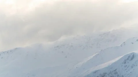 Snow blowing over mountain Stock Footage 5503060