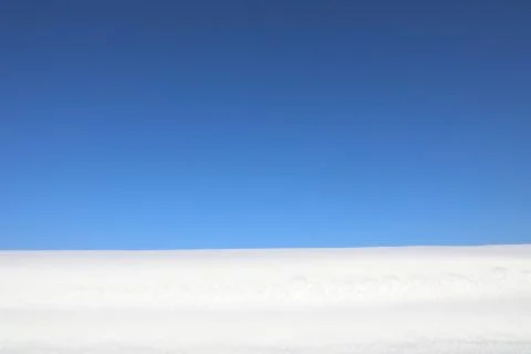 Snow on blue sky background Stock Photos