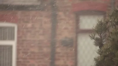 Snow on blurry building and tree Stock Footage 22276760