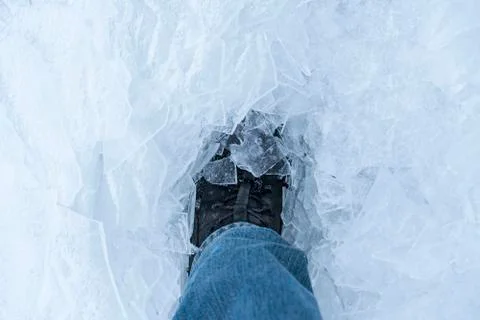 A snow boot close up shot of a ice shoe standing and walking in fresh white p Stock Photos