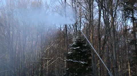 Snow cannon with forrest trees in background - downward motion Video stock 10595387