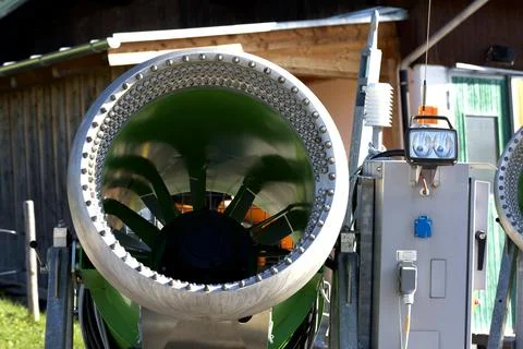 Snow cannon machine creating artificial snow for ski slopes Stock Photos