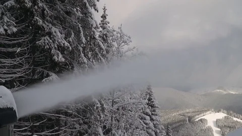 The snow cannon makes artificial snow on the slope of the mountain ski resort Stock Footage 85216575