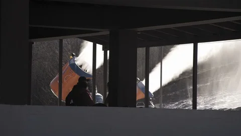 The snow cannon makes artificial snow on the slope of the mountain ski resort Stock Footage 97795426