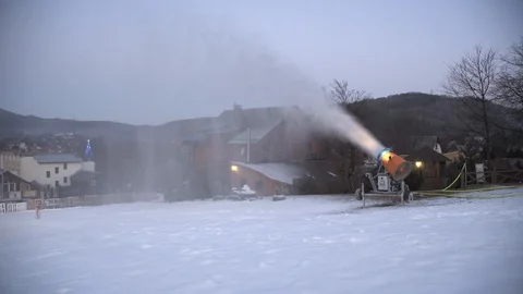 The snow cannon makes artificial snow on the slope of the mountain ski resort Video stock 97796507