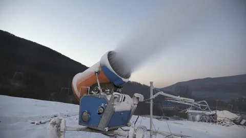 The snow cannon makes artificial snow on the slope of the mountain ski resort Stock Footage 97796638