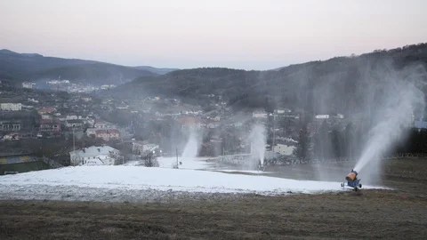 The snow cannon makes artificial snow on the slope. Winter sports 動画素材 97796918