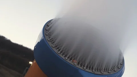 The snow cannon makes artificial snow on the slope of the mountain ski resort Stock Footage 97797006