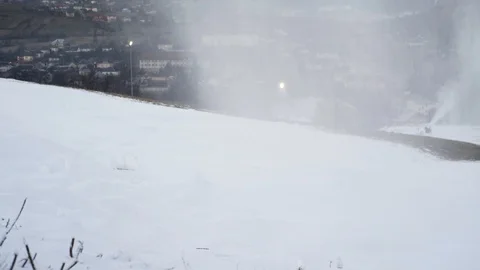 The snow cannon makes artificial snow on the slope. Winter sports 스톡 동영상 97797019