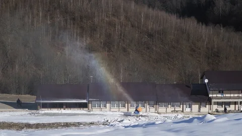 The snow cannon makes artificial snow on the slope. Winter sports. Rainbow Stockbeeldmateriaal 97797967