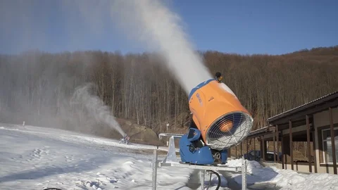 The snow cannon makes artificial snow on the slope. Winter sports Video stock 97815617