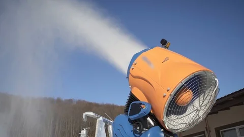 The snow cannon makes artificial snow on the slope of the mountain ski resort 動画素材 97815729