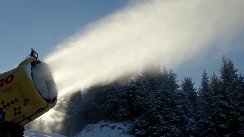 Snow cannon making artificial snow on slope against sunrise, SLOW MOTION Stock Footage 71841676