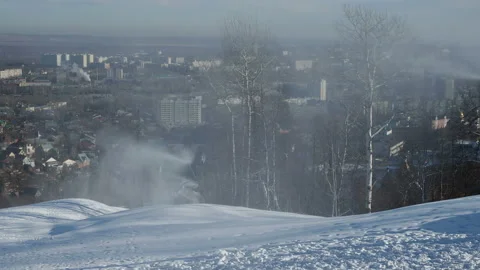 Snow cannon preparing a slope to ski in the background of the urban landscape Stock Footage 143684006