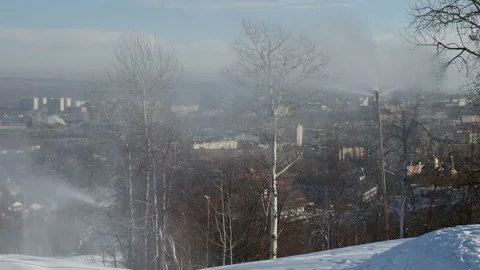 Snow cannon preparing a slope to ski in the background of the urban landscape Vidéo 144194579