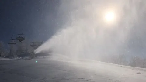 Snow cannon in the process of snowmaking on the ski slope Stock Footage 149215166