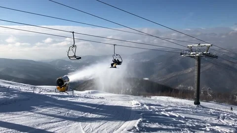 Snow cannon in the process of snowmaking on the ski slope Stock Footage 149215251