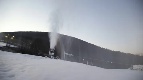 The snow cannon's makes artificial snow on the slope of the mountain ski resort Video stock 97796583