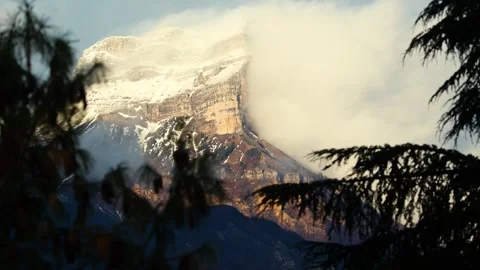 Snow caped mountain with clouds and mist. Stock Footage 258614814