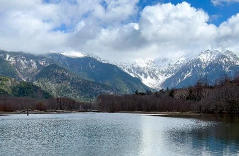 Snow-capped Alps reflected in the lake. Stock Photos