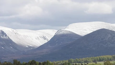 Snow-capped Cairngorm mountains on cloudy day Stock Footage 335540170