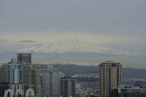 Snow-capped Mount Rainier towering behind the Seattle skyline in Washington Stock Photos