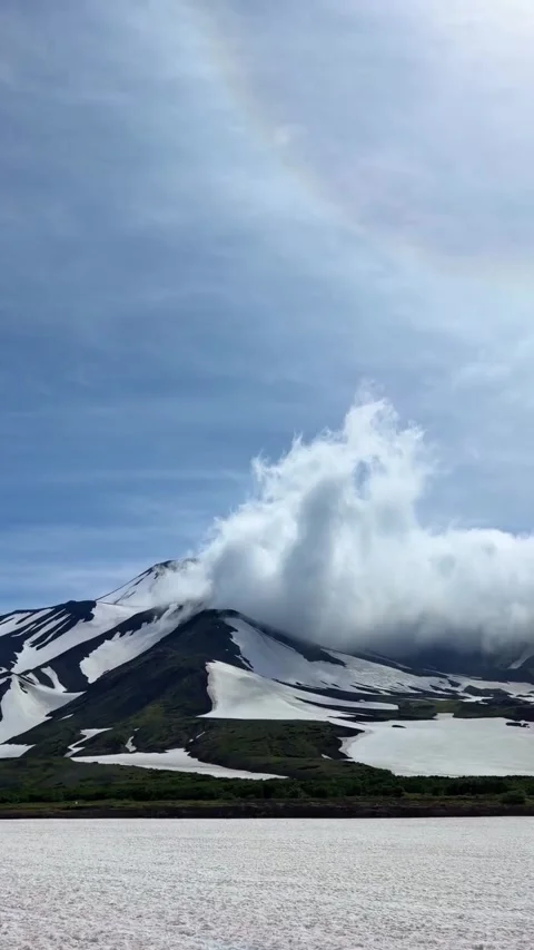 Snow-Capped Mountain and Clouds Over Snowy Landscape Video stock 341133247