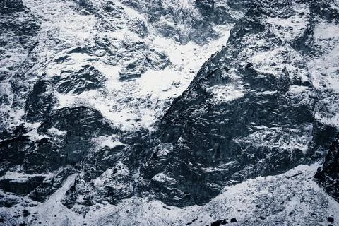 Snow-capped mountain close-up. The texture of the stones in the snow Stock Photos