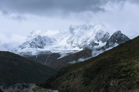 Snow-capped mountain in cloudy sky Stock Photos