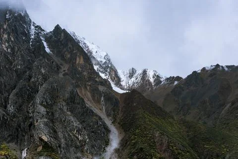 Snow-capped mountain in cloudy sky Stock Photos