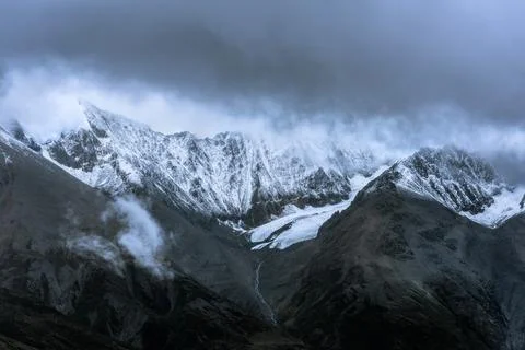 Snow-capped mountain in cloudy sky Stock Photos