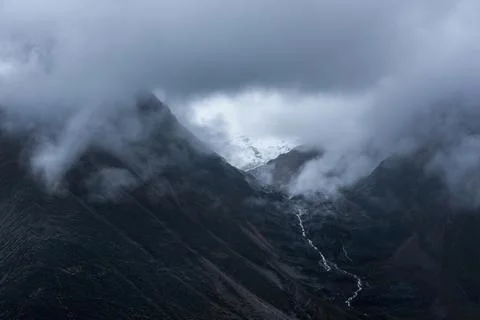 Snow-capped mountain in cloudy sky Stock Photos