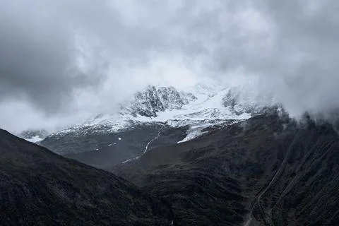 Snow-capped mountain in cloudy sky Stock Photos