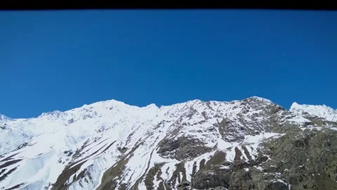 Snow-Capped Mountain Exploration in Shinkula Pass Through the Car's Side Mirror Stock Footage 247756304