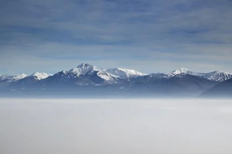 Snow capped Mountain over Cloudscape with Blue Sky in Ticino Switzerland Europe 写真素材