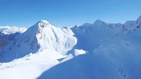 Snow-capped mountain peak and  ridge on  horizon aerial view Stock-Footage 84907308