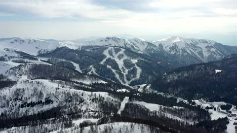 Snow-capped mountain peaks and a coniferous forest with fir trees in winter Stock Footage 152309290