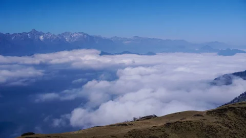Snow-Capped Mountain Peaks Emerging Through Rolling Cloud Sea at Twilight Stock Footage 341912282
