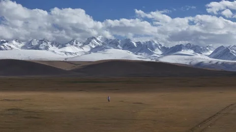 Snow capped mountain range above plateau in Hejing Xinjiang China Stock Footage 337912453