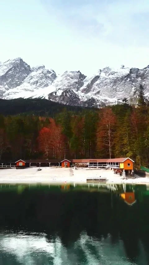Snow-Capped Mountain Range Over Alpine Lake in Autumn Stock Footage 337322899