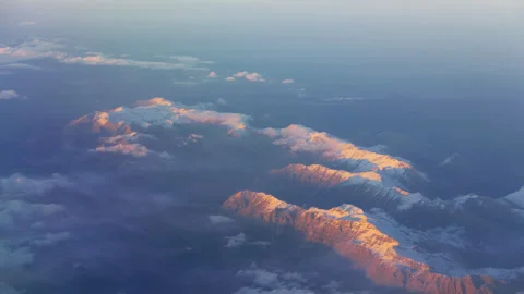 Snow capped mountain range seen from flight window Stock Footage 318354793