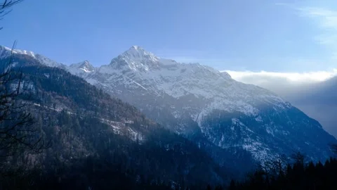 Snow-Capped Mountain Range Under Blue Sky Stock Footage 303866633